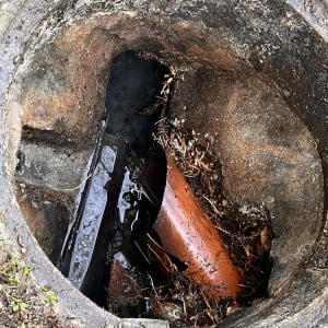 צינור שבור בתוך בור ביוב עם מים ולכלוך