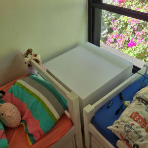 שולחן עץ לבן בין שתי מיטות ילדים