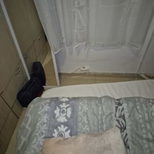 שקע חשמל ליד מיטה עם וילון