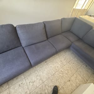 ספה אפורה בחדר עם רצפת אריחים
