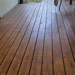 רצפת עץ בגינה עם כיסא ושולחן