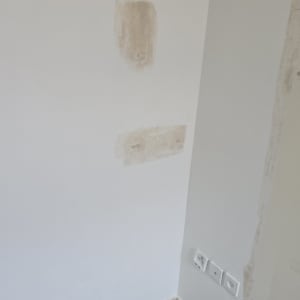 קיר עם תיקוני טיח והכנה לצביעה