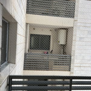 רשת מתכת מותקנת למניעת כניסת יונים במרפסת