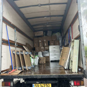 משאית פתוחה עם קרטונים וציוד הובלה