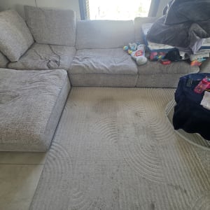 ספה אפורה עם צעצועים ושולחן קטן