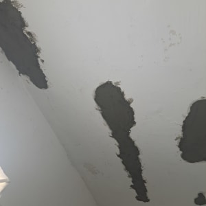 תיקוני טיח כהים על תקרה לבנה