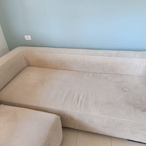 ספה עם כתמים על רקע קיר כחול