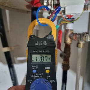 מד זרם חשמלי מחובר לצינור עם חוטים צבעוניים