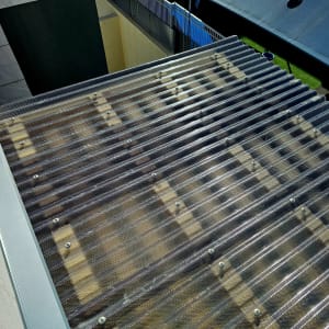 גג פלסטיק גלי עם ברגים על מסגרת עץ