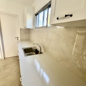 שיש חדש עם כיור וברז במטבח משופץ