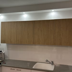 ארונות מטבח מעץ מעל כיור ומשטח עבודה