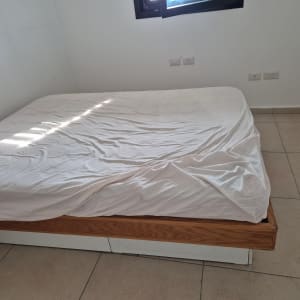 מיטה עם מצעים בחדר ריק