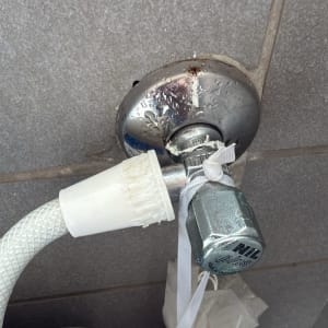 חיבור צינור מים עם ברז על קיר אריחים