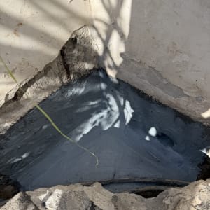 פינה עם חומר איטום אפור על קיר בטון