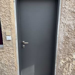 דלת אפורה מותקנת בקיר חיצוני