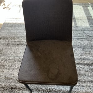 כיסא עם כתמים על המושב, עומד על שטיח