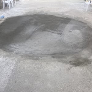 תיקון בטון על משטח חיצוני עם כיסאות פלסטיק ברקע