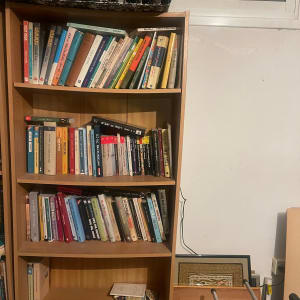 מדף ספרים עם ספרים ותיקיות במשרד או חדר עבודה