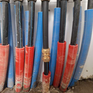 צינורות שחורים עם חיבורים ומעטפת אדומה וכחולה