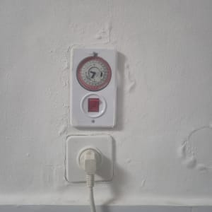 שעון טיימר ומתג חשמלי על קיר