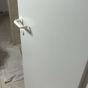 דלת לבנה עם ידית בחדר אמבטיה