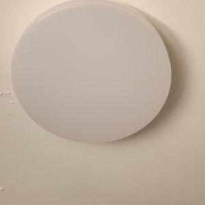 מנורת תקרה עגולה מותקנת על תקרה לבנה