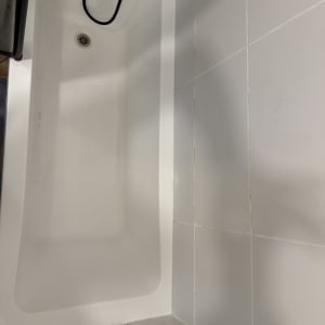 אמבטיה עם אריחים לבנים וברז שחור