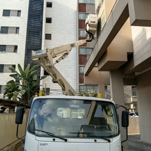 משאית עם מנוף ליד בניין מגורים
