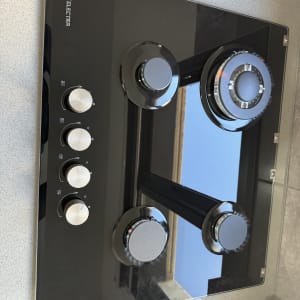 כיריים גז שחורות עם כפתורים לבנים