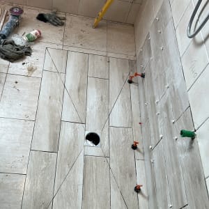 ריצוף קרמיקה עם כלי עבודה באתר שיפוצים