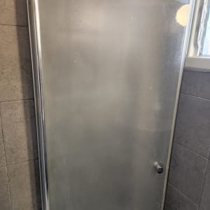 דלת זכוכית למקלחת עם מסגרת מתכת