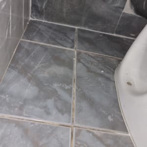 רצפת אריחים אפורה עם פינות מלוכלכות