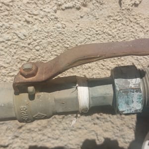 שסתום מתכת עם ידית חלודה על צינור