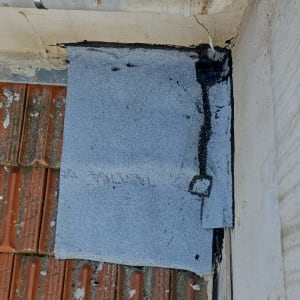 חומרי איטום על גג עם רעפים וצינור מתכת