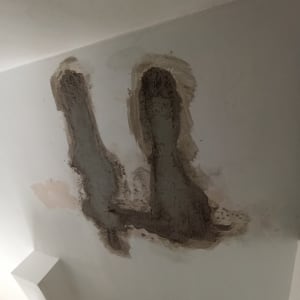 תיקון טיח בתקרה עם טלאים כהים