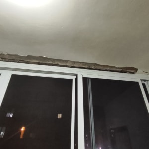 תקרה עם קילוף טיח מעל חלון זכוכית