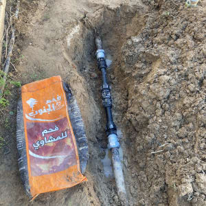 תמונה של צינור מים באדמה עם שקית פחם