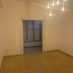 חדר ריק עם רצפה נקייה ותאורה תלויה