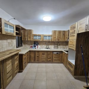 מטבח עם ארונות עץ ודלתות זכוכית