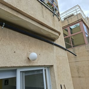 בניין עם מרפסת וצינור חיצוני