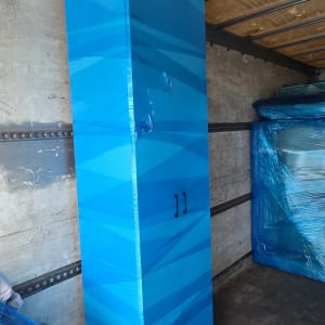 ארון כחול עטוף בניילון בתוך משאית הובלה