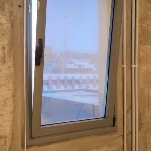 חלון עם תריס גלילה לבן וחוט משיכה