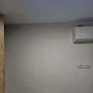 קיר לבן עם שקעי חשמל ותאורה עגולה