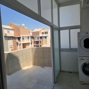 מרפסת עם חלונות אלומיניום ומכונת כביסה