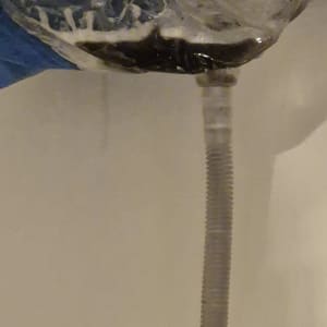 צינור ניקוז ממזגן עם שקית פלסטיק לאיסוף מים