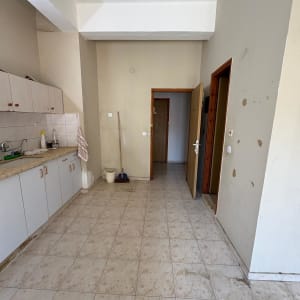 מטבח ריק עם ארונות וכלים לניקוי