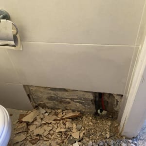 קיר שבור עם צינור חשוף ועבודת אינסטלציה