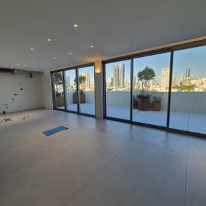 חדר ריק עם חלונות גדולים ונוף עירוני