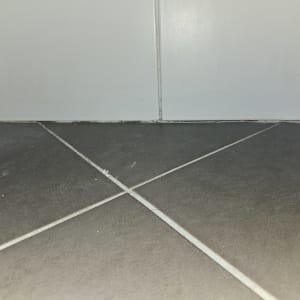 רצפת אריחים עם קו חיבור לקיר לבן