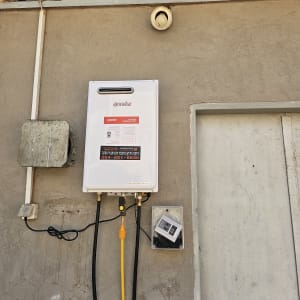 מחמם מים גז מותקן על קיר עם צינורות